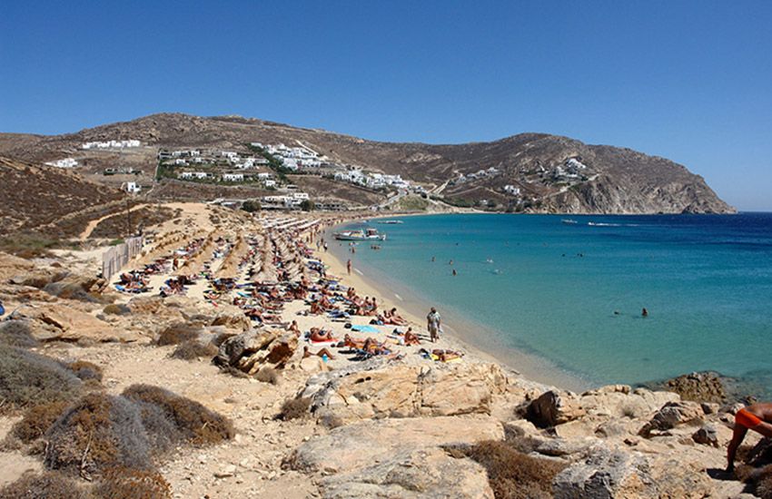 Elia Beach, Mykonos: popular gay beach with golden sand, crystal waters, and packed sun loungers.