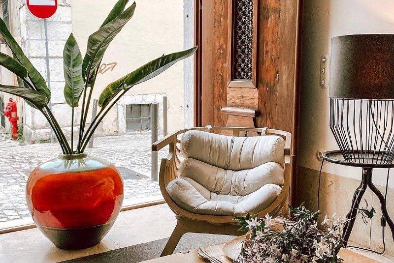 Cozy and stylish hotel lobby at The Late Birds Lisbon with modern decor and natural light, welcoming LGBTQ+ travelers to Portugal.