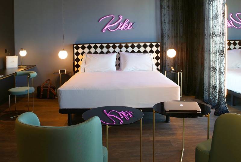 A stylish hotel room with neon 